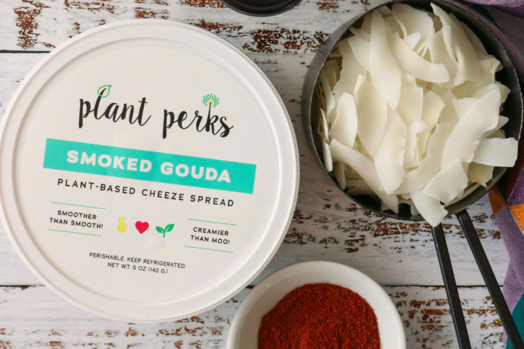 plant perks smoked gouda cashew cheese container next to coconut chips and paprika
