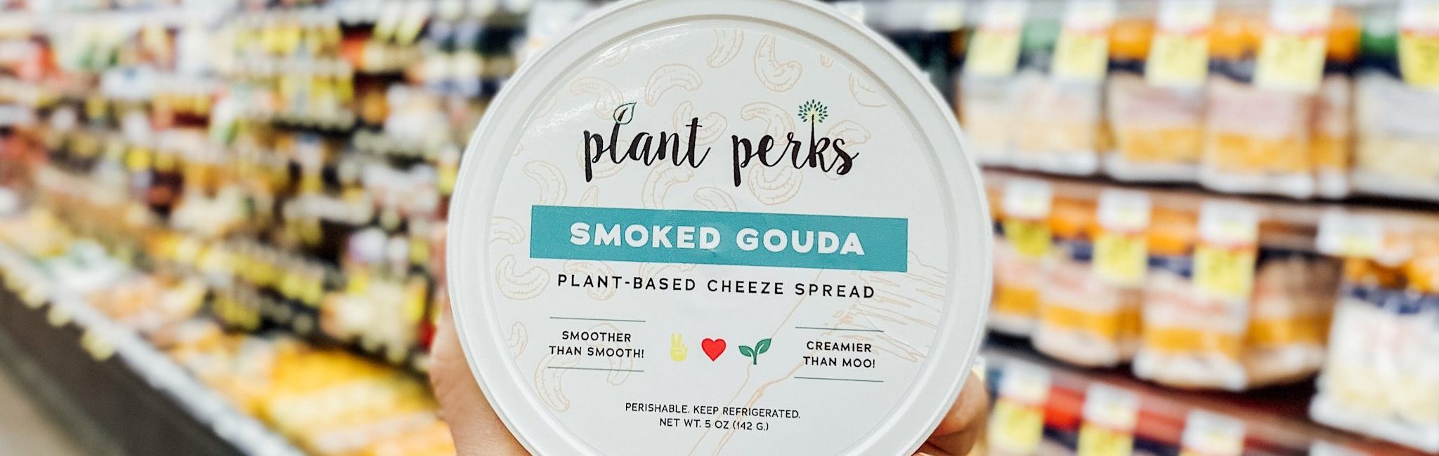 Plant Perks Smoked Gouda Vegan Cheese container in a grocery store