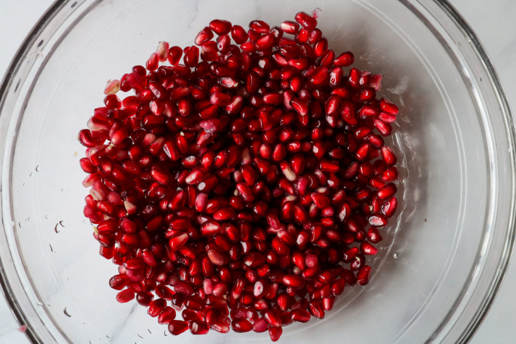 pomegranate seeds in a clear bowl